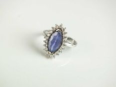 An 18ct white gold tanzanite and diamond cluster ring