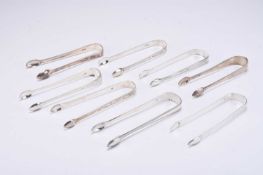 A collection of eight silver sugar tongs