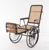 A 20th century iron framed wheelchair