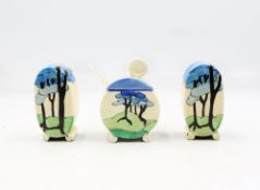 Clarice Cliff; a three piece condiment set comprising of a mustard pot, salt shaker and