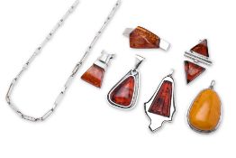 A GROUP OF POLISH MODERNIST SILVER AND AMBER PENDANTS AND A SILVER CHAIN