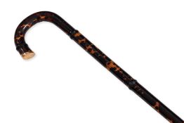 A GOLD MOUNTED AND FAUX TORTOISESHELL WALKING STICK