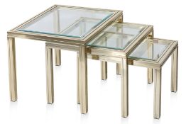 A NEST OF THREE BRASS AND GLASS SIDE TABLES BY PIERRE VANDEL