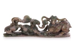 A SERPENTINE JADE CARVING OF THREE RAMS