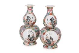 A PAIR OF FAMILLE ROSE MILLEFLEURS DOUBLE GOURD PORCELAIN VASES