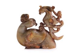 A CELADON AND RUSSET JADE CARVED MODEL OF TWO PHOENIX