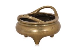 A POLISHED BRONZE TRIPOD CENSER