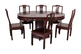 A BLACKWOOD DINING TABLE AND SET OF SIX CHAIRS