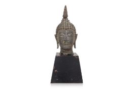 A THAI BRONZE HEAD OF BUDDHA ON WOOD STAND