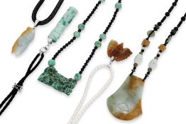 A GROUP OF FIVE JADE PENDANTS