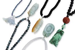 A GROUP OF FIVE JADE PENDANTS