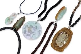 A GROUP OF FIVE JADE PENDANTS