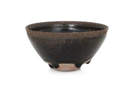 A BLACK GLAZED STONEWARE BOWL