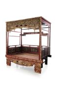 A LARGE CARVED AND PARCEL GILT WEDDING BED