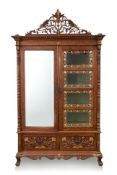 A LARGE CARVED AND GILT TEAK CABINET