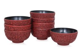 A SET OF EIGHT CARVED CINNABAR LACQUER BOWLS