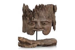 A LARGE HARDWOOD SCULPTURE OF A CHILD'S FACE