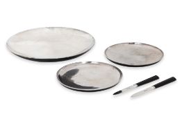 GERALD BENNEY - A SET OF SILVER AND BLACK ENAMEL DISHES