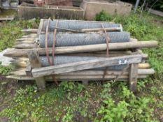 Quantity of 3 inch wooden fence posts. C/w 5No. rolls of mesh