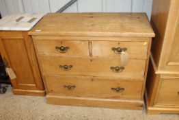 An antique stripped pine chest fitted two short ov