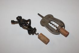 A large bronze cherub corkscrew, 17cm overall; and