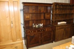 An Ipswich oak style dresser fitted three drawers,