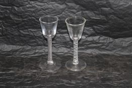 Two drinking glasses having air twist stems, rough