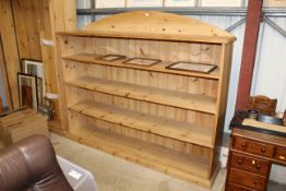 A pine open fronted bookcase, measuring in extreme
