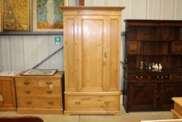 A stripped pine single door wardrobe fitted single