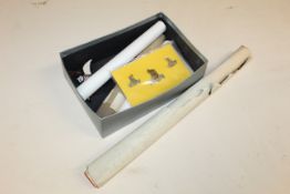 A box containing WWII poster with various scrolls,