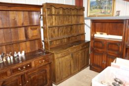 An oak dresser, the upper section fitted three gra