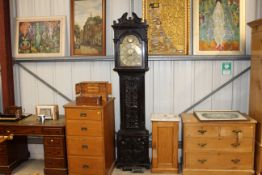 An antique carved oak cased grandfather clock, the