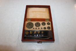A set of weights in mahogany fitted case, signed L