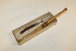 A hoof handled page turner and a horn handled toasting fork