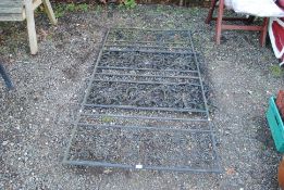 A pair of ornate wrought metal driveway gates, eac