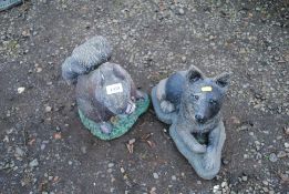 Two garden ornaments in the form of a seated dog a