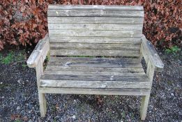 A hardwood two seater garden bench