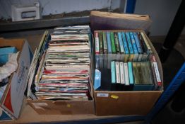Two boxes containing various cassettes and records