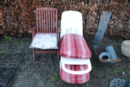 A white plastic folding garden lounger with cushio