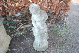 A concrete statue of a seated maiden holding a wat