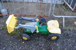 A child's pedal tractor with loader and tipping bu