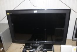 A Sony flat screen television and remote control