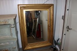 A gilt framed wall mirror