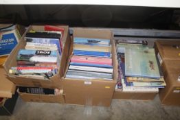Four boxes containing various books, some relating