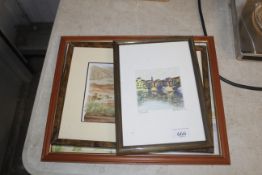 A framed and glazed watercolour study depicting a village indistinctly signed to the bottom right, a