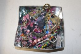 A tin and contents of various costume jewellery to