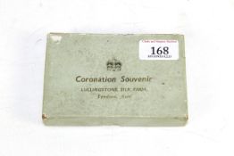 A Coronation souvenir from Lullingstone Silk Farm of Kent containing a skein of raw silk, two silk