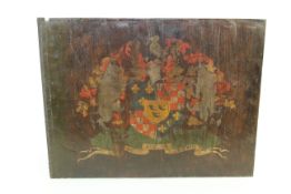 An antique painted crest on oak panel