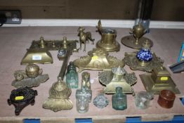 A quantity of brass inkwells and ink bottles and a brass twin ink stand