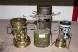 Three camping stoves in tin cases, one named to Stesco